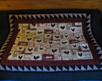 A quilted table cloth of Chickens and Roosters . Memories of growing up on the farm.
