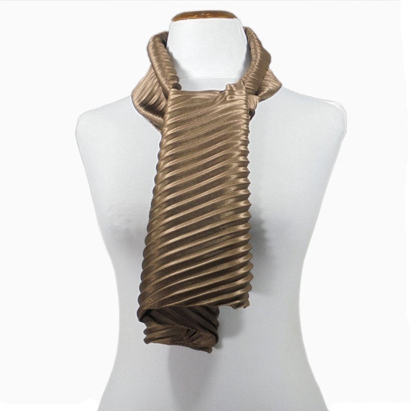 Scarf pleated in light brown satin with diagonal folds and