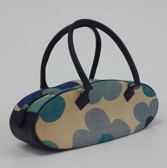 Blue floral printed canvas oval shape bag top handle bag.