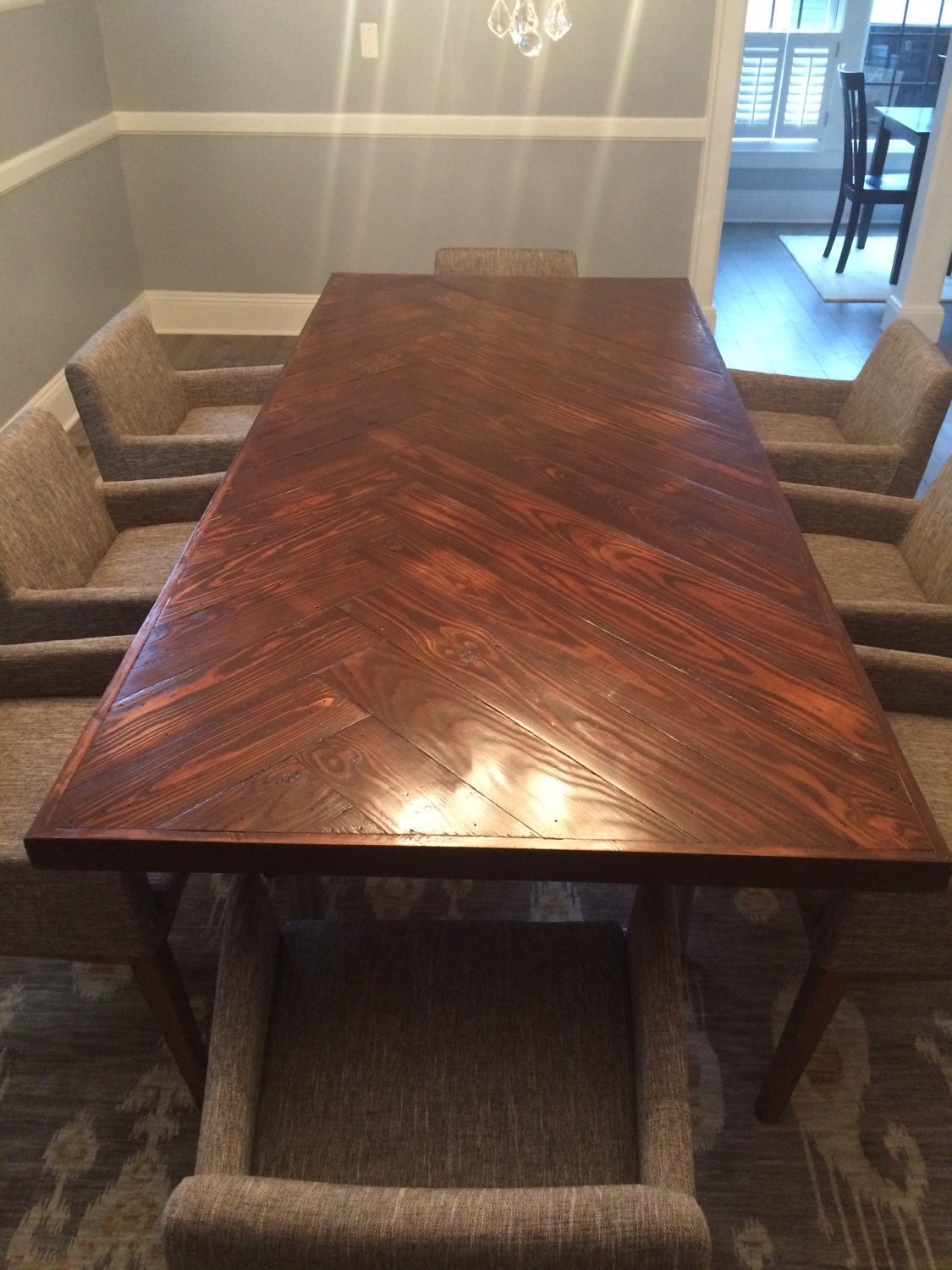 Asymmetrical herringbone dining room table