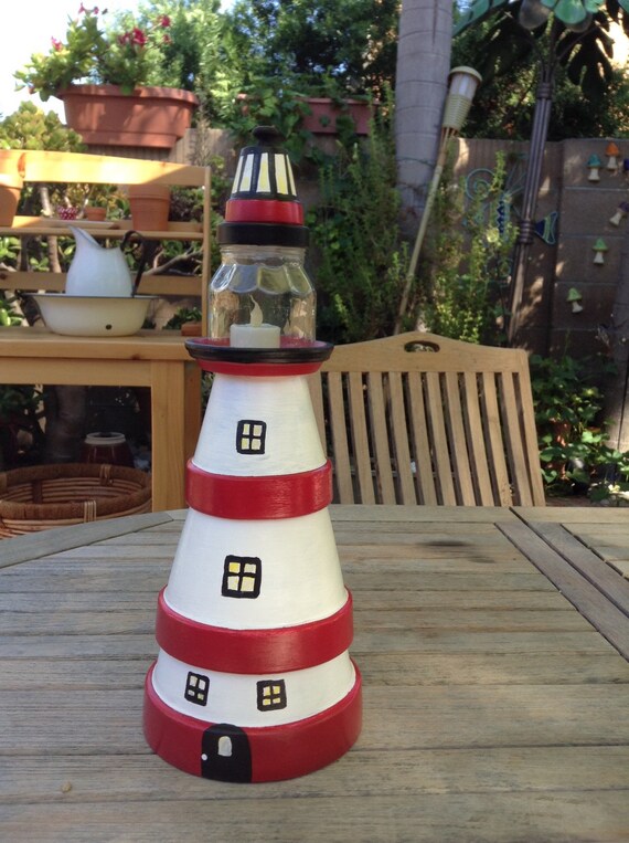 Lighthouse made from clay pots to use as home accent or yard