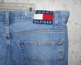 Vintage 1990s Tommy Hilfiger Jeans Large Flag Logo Cotton Denim Name Printed Down Leg Seams Hipster Retro Spellout Mens Size 38 / 32