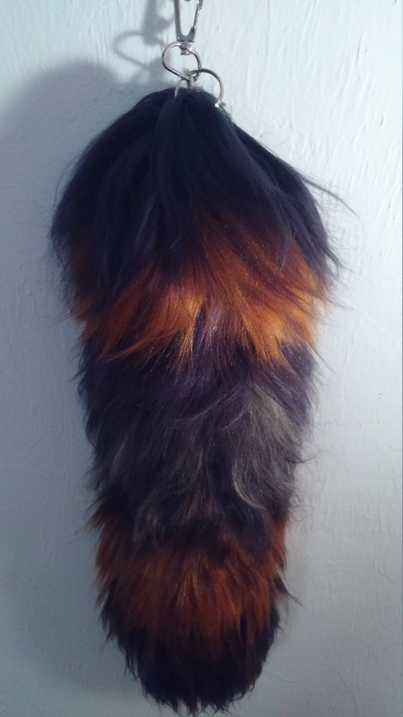 Items similar to black and orange faux fur tail, yarn tail on Etsy