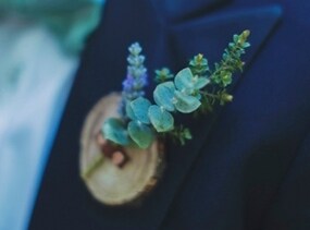 Rustic wooden boutonnieres with leather strapping