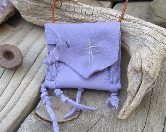 Leather pouch...Midnight Lightning...This Wisdom Pouch is made out of a beautiful purple deerskin leather and features hand carved symbols.