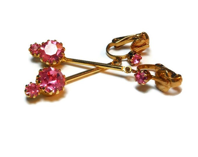 Pink rhinestone earrings, gold clip dangle earrings, prong set rhinestone on ear then a swinging bar with two more rhinestones at bottom