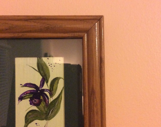 Trio of flowers, framed in oak