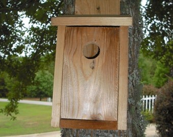 Cedar bird house for blue birds and wrens, with clean out panel