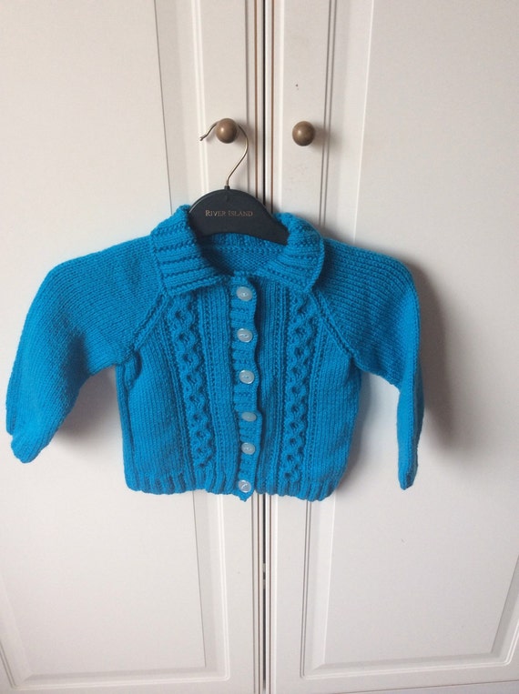 Hand knitted childs turqoise cardigan