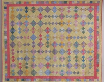 Queen size quilt. Cottage style Four patch quilt Scrap quilt. Pink backing. Hand quilted. Finished size 84" x 98".