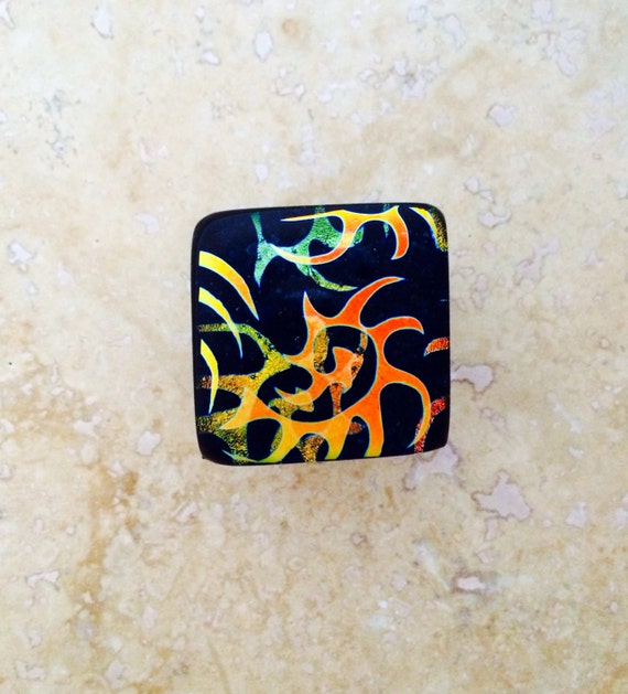Dichroic Glass Cabinet Door Pull in Gold, Orange and Green over Blue Aventurine Glass with Oil Rubbed Bronze Hardware.