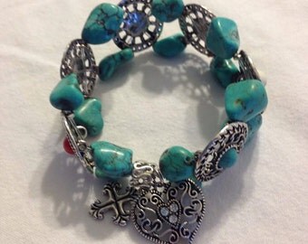 Silver plated bracelet with turqoise/white/red stones. Stretchable bracelet.