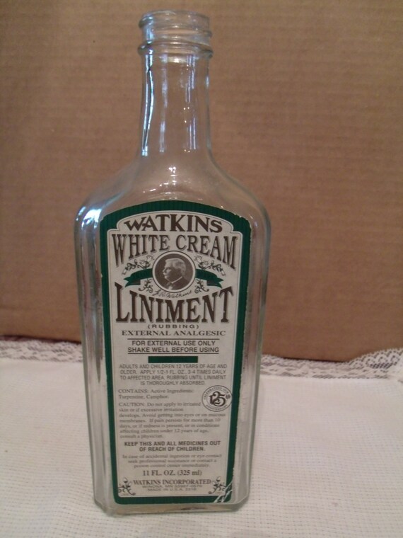 Clear Glass Bottle With Watkins White Cream Liniment Label