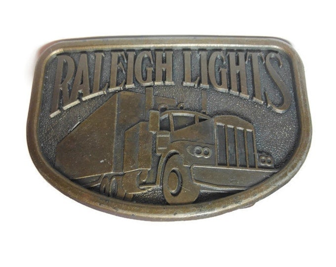 FREE SHIPPING Raleigh Lights belt buckle, brass western belt buckle, showing truck, trucker belt buckle vintage