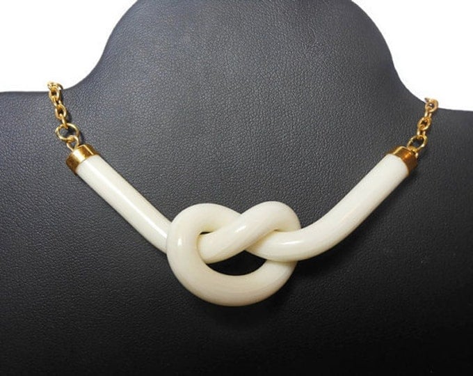 Cream knot focal charm, acrylic and gold-finished, opaque striated , 3" x1" knot, 2 loops, almost instant necklace or get creative