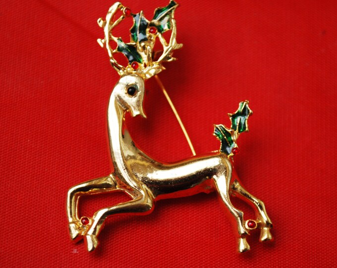 Vintage Christmas Reindeer Brooch Gold tone with red rhinestones and green enamel Holly Holiday Pin