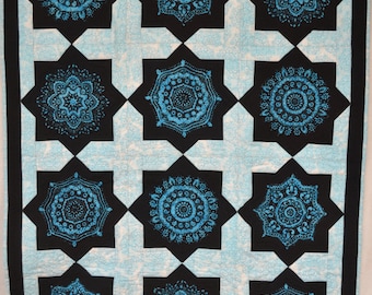 Quilted wall hanging or lap quilt. Machine pieced and quilted in beautiful spiraled turquoise and blacks