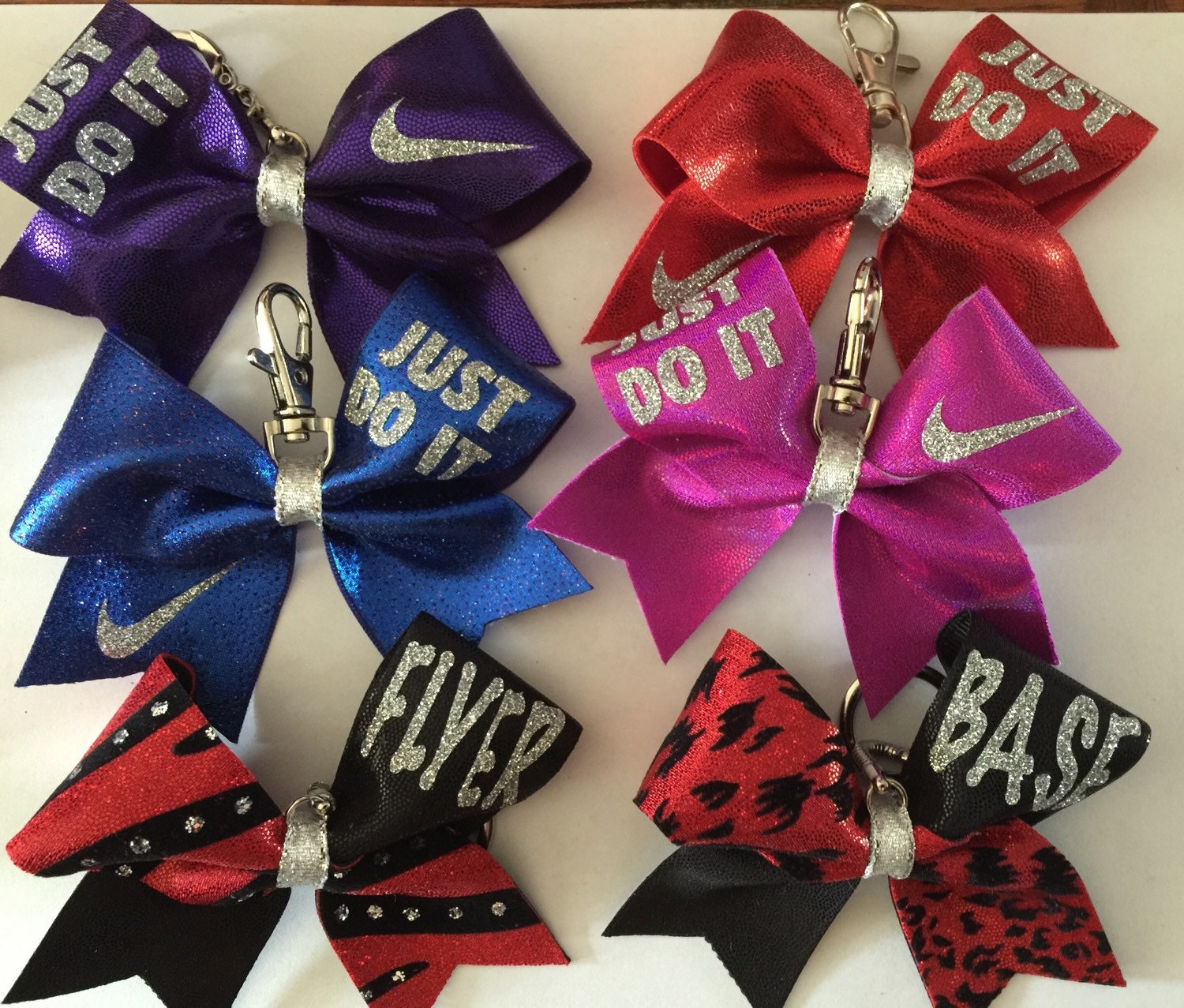 Mini cheer bow keychains with designs or lettering. ex.