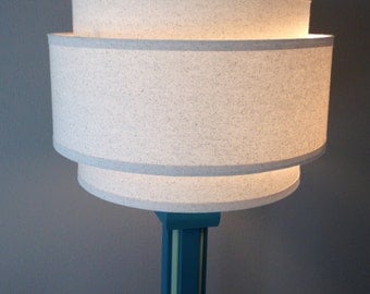3 Tiered hardback lamp shade in off-white muslin fabric with edge trimming, best for floor lamps. Free shipping to lower 48 states.