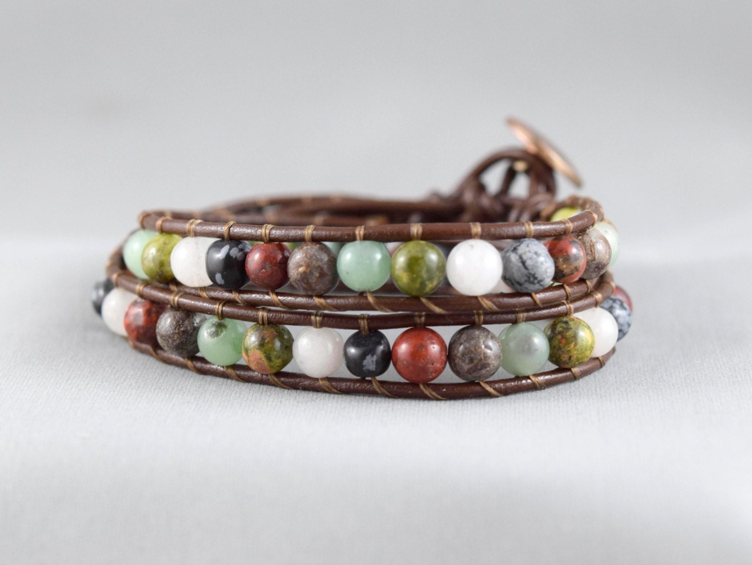 Brown leather wrap bracelet with a mix of gemstone beads