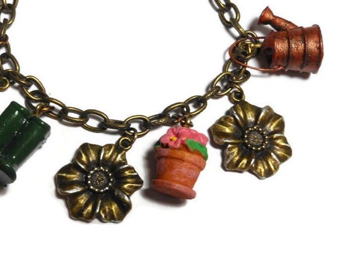 Gardening charm bracelet, upcycled colorful garden charms mixed with bronzed flowers with silver highlights on a bronze link bracelet