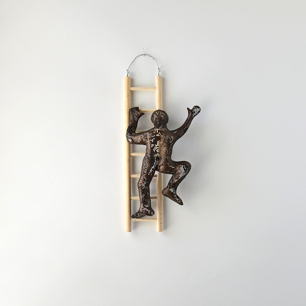 Metal wall art Climbing man sculpture on wood ladder