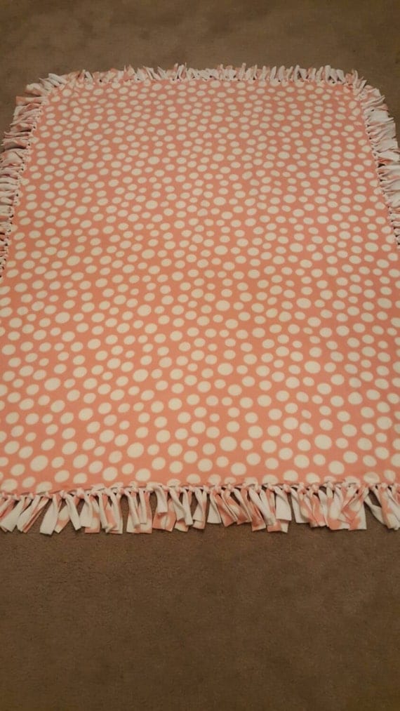 Pink and white polka-dot fleece blanket