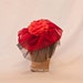 Handmade red and black ladies hat decorated with a red flower