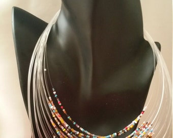 Multi-colored, layered, traditional wire necklace with matching earrings.