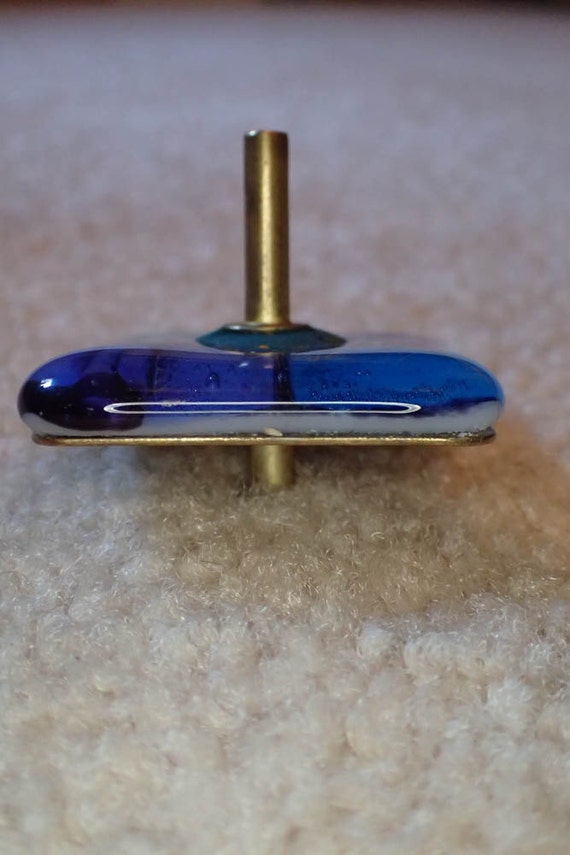 Blown glass brass handmade toy spinning top by AtiovAtelierCo