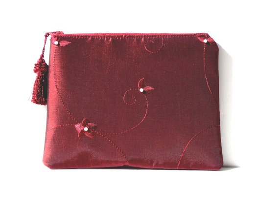 burgundy and gold clutch bag