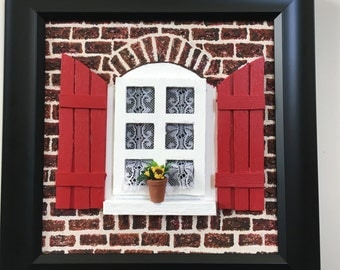 Painting of red window on brick house
