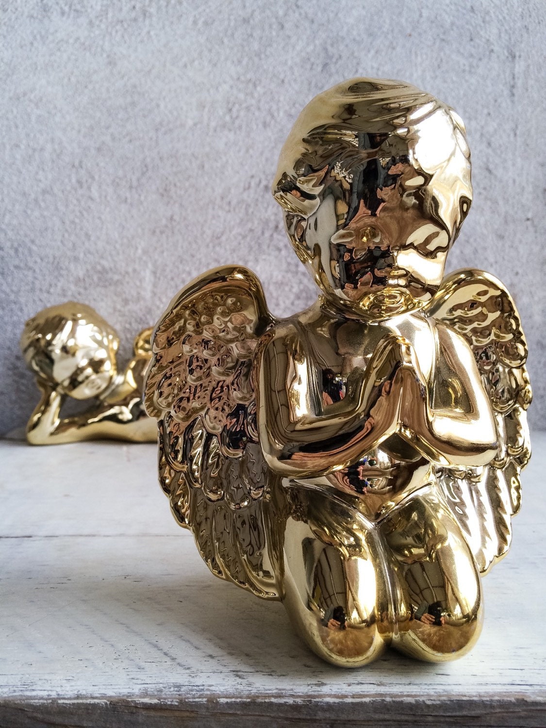 Pair of vintage shiny gold porcelain cherub statues shiny