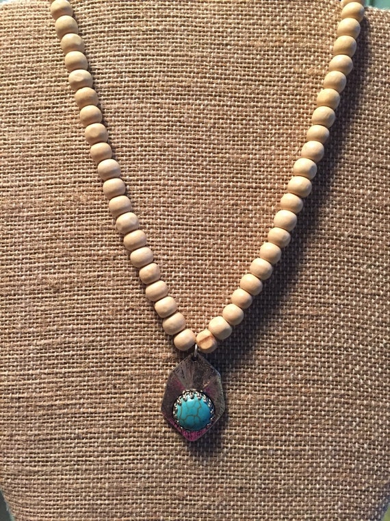 Items similar to Wood bead necklace with charm on Etsy