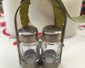 Glass salt and pepper shakers in a metal holder