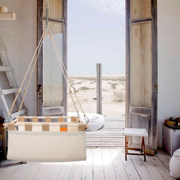 Hanging baby cradle on a spring from natural materials and