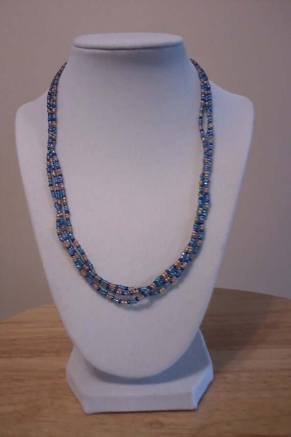 Items similar to Twisted 3strand beaded necklace, blue/gold on Etsy