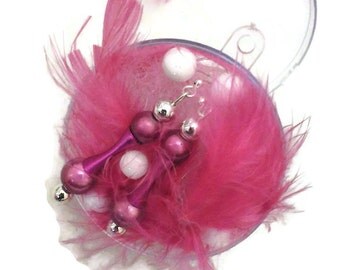 Dangling earring is purple and pink