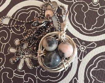 Beautiful speckeld 3 eggs in birds nest with silver chain