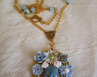 Ravissant collier avec pendentif en bois et céramique "Un visage entouré de fleurs"
