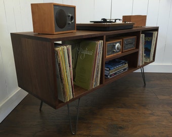 Mid century modern record player console, turntable, stereo cabinet with LP album storage featuring black walnut with steel hairpin legs.