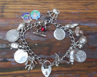 vintage sterling silver charm bracelet with 15 coins and charms
