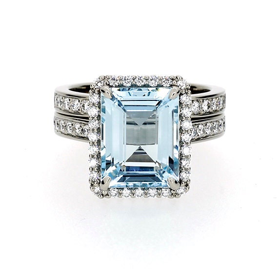 Platinum halo engagement ring set with emerald cut Aquamarine