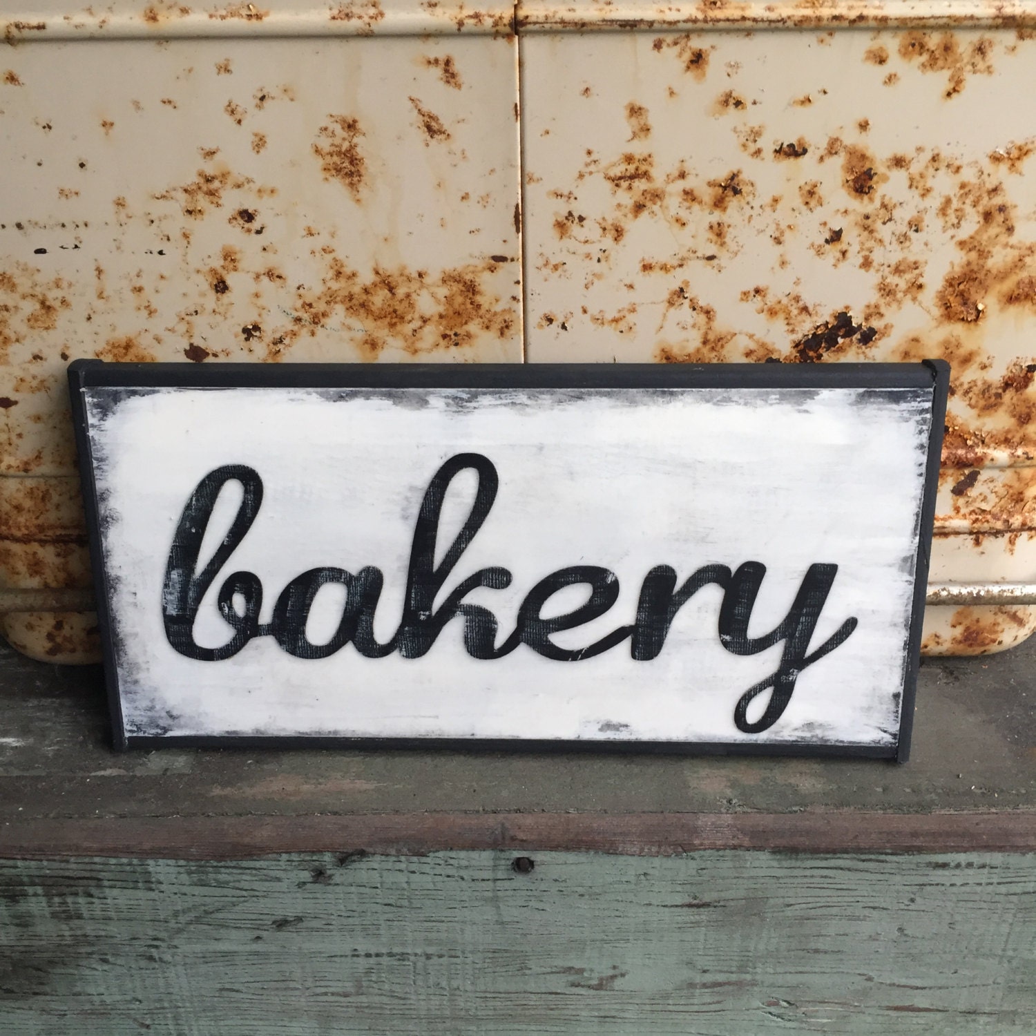 Bakery handmade sign with cursive writing and black frame