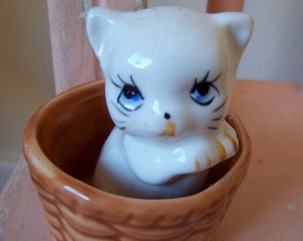 tiny kitten in a basket figurine