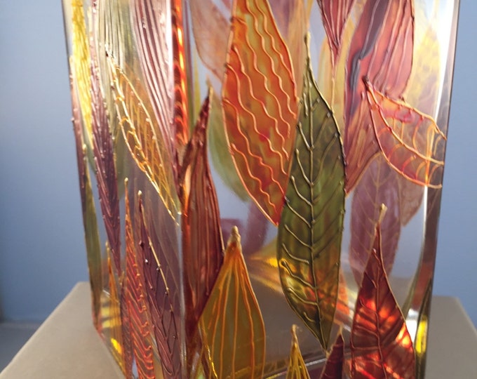 Glass rectangular vase with autumn leaves