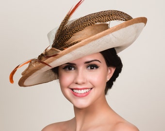 Kentucky Derby Hat. Ivory Sinamay with Golden Bronze Trim. Natural Brown Orange Pheasant Feathers. 5" Wide Asymmetrical Tilt Brim.