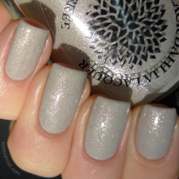 Light gray shimmer nail polish with flakies by Black Dahlia
