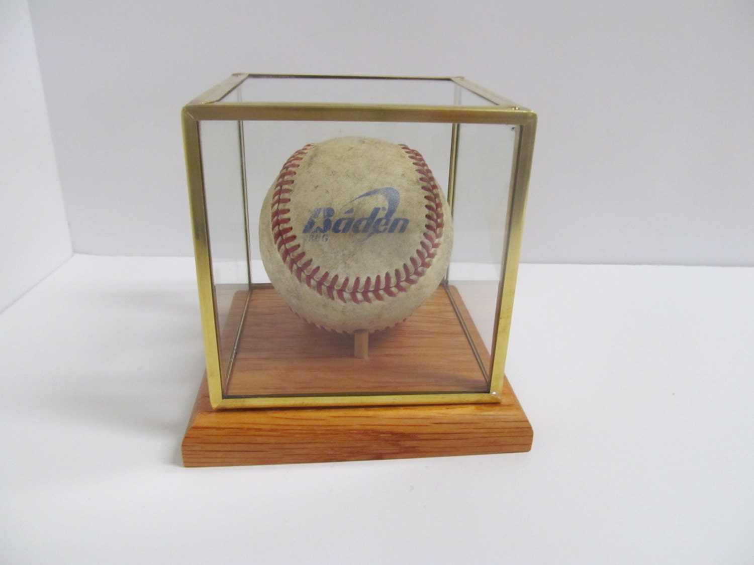 Glass and brass baseball display case with an handmade oak