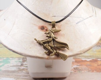 Witch pendant. Witch with broom. halloween jewelry. Pendant in bronze. Halloween pendant.